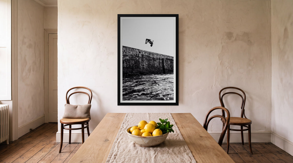 Backflip, framed in black with a white mat on a wall at home