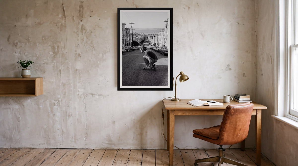 Bomb Hill, framed in black with a white mat on a wall at home