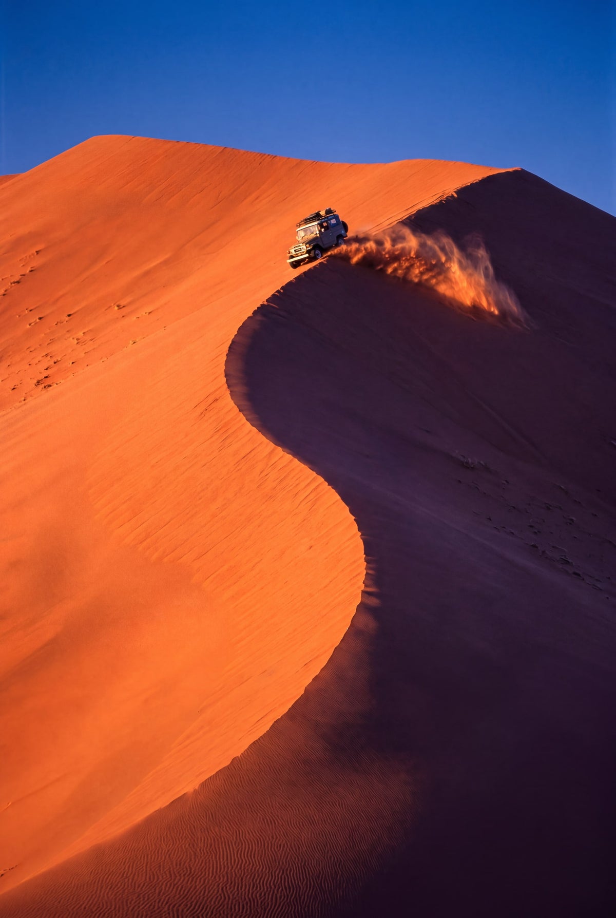 Sossusvlei: Land Cruiser on a red dune in Namibia art print